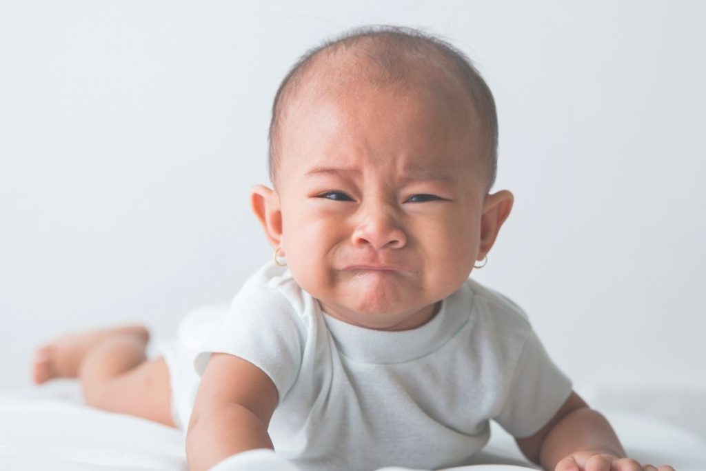 crying baby on belly